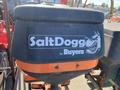 A black and orange SaltDogg salt spreader with a wolf graphic and the text SaltDogg by Buyers on its side