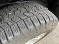 Close-up of a tire with deep treads mounted on a wheel of a 2012 GMC Canyon