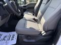 Interior view of a 2022 Ford F600 showcasing two front seats with fabric upholstery and a center console visible between them