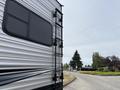 A 2021 Jayco Jay Flight travel trailer with a sleek exterior featuring a prominent side window and ladder for access to the roof