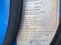 1997 Genie S-65 4X4 with a specification label detailing weight height and hydraulic lift capacity