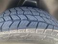 Close-up of a tread pattern on a tire designed for a 2021 RAM 1500 showcasing deep grooves and rugged features for traction