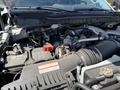 Close-up view of the engine compartment of a 2024 Ford F-550 Super Duty showcasing various components like the battery and hoses