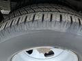 Close-up of a tire on a 2017 Chevrolet Express showcasing the tread pattern and wheel rim