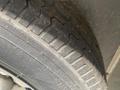 Close-up of a tire from a 2020 Stealth Enterprises Trailer showing tread patterns and dirt on the surface
