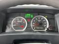 Dashboard of a 2022 Isuzu NPR featuring speedometer and tachometer displays along with various warning lights and a digital readout