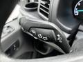 Close-up of a 2020 Ford Transit steering wheel control stalk featuring buttons for turn signals and headlights