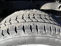 Close-up of a textured tire with a rugged tread pattern mounted on a 2018 GMC Sierra 1500