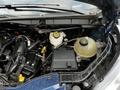 Close-up of the engine compartment of a 2020 Ford Transit showcasing various components including the coolant reservoir and battery