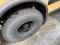 Close-up of a large tire from a 2009 International 3000 bus featuring rugged tread and a black rim with the label XDN2 on the sidewall