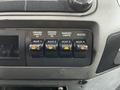 Dashboard switches of a 2016 Ford F-550 featuring controls for driving lights marker lights and a heater with illuminated indicator lights