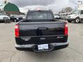 A black 2004 Ford Explorer Sport Trac with a pickup bed and visible tailgate and license plate