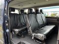 Interior of a 2020 Ford Transit showing black leather seats in the rear passenger area with a spacious layout and no occupants