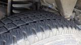 Close-up of the tread on a tire from a 2011 Ford Econoline showing detailed patterns and wear on the rubber surface