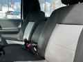 Interior of a 2010 Ford Ranger showing two front seats with fabric upholstery in black and gray sections and seatbelts attached
