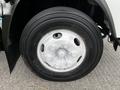 Close-up of a white wheel on a 2022 Isuzu NPR featuring a six-bolt pattern and a Bridgestone tire with the brand name clearly visible on the sidewall