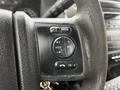 Close-up of the steering wheel controls of a 2016 Ford F-550 featuring buttons for media, seek, volume, and an OK confirmation