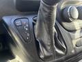 Gear shifter of a 2021 RAM Promaster showing positions for tow haul reverse neutral and drive with a leather boot