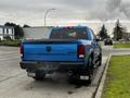 Blue 2021 RAM 1500 Classic truck parked with dual exhaust visible and 4x4 badge on the tailgate