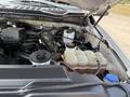 Engine compartment of a 2020 Ford F-350 SD showing various components including coolant reservoir and other engine parts
