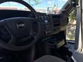 Interior view of a 2020 Chevrolet Express showcasing the steering wheel and dashboard controls including radio and climate settings