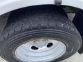 A close-up of a 2015 Ford F-550 tire showcasing the tread pattern and rim design