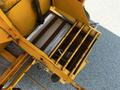 A yellow metal vehicle part with a rectangular shape features slats and a rusted appearance designed for a 2005 Volvo VND 122