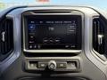 A close-up view of the touchscreen infotainment system in a 2022 GMC Sierra 1500 displaying radio options and settings