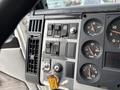 Dashboard of a 1998 Freightliner FL80 featuring gauges for oil water and volts alongside various switches and controls