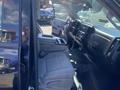 Interior of a 2014 GMC Sierra 1500 showing a driver's seat and center console with gray upholstery and dashboard controls