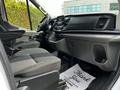 Interior of a 2022 Ford Transit showing front seats dashboard and controls with a floor mat that reads Thank You