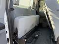 Interior view of the back seat area of a 2012 Ford F-350 SD with gray fabric upholstery and a folding rear bench seat
