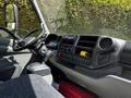 Interior view of a 2018 Hino 195 truck showing the dashboard controls and gear shift with a focus on the driver's seat and console