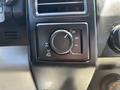 A close-up of a 2016 Ford F-150 control panel featuring a rotary dial for selecting drive modes labeled 2H 4H and 4L along with a pull mechanism