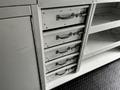 A metal storage unit with several drawers and shelves designed for organization in a vehicle or workspace