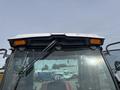 Front view of a 2012 Toro Groundsmaster 5910 showing the windshield wipers and orange lights mounted on the roof