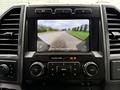 Screen display showing a rearview camera view in a 2022 Ford F600 with controls below for volume and media