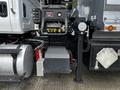 A 2017 International WorkStar 7600 truck's engine compartment showing the battery box and power connections with various controls and gauges