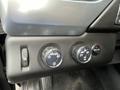 A control panel featuring knobs for headlight settings and four-wheel drive options in a 2016 Chevrolet Tahoe