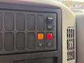 Control panel of a 2011 International 4300 featuring various switches and buttons including an on switch and indicator lights