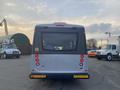 A 2017 Chevrolet Express rear view with taillights and a large window showcasing the interior