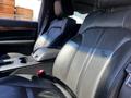 Black leather seats of a 2013 Lincoln MKT with armrests and seat controls visible in the foreground