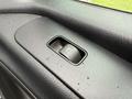 Close-up of the window control switch on the door panel of a 2019 Mercedes-Benz Sprinter with water droplets on the surface