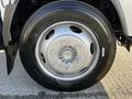 A close-up of a silver wheel on a 2017 Isuzu NQR showing six lug nuts and a black tire with visible tread patterns