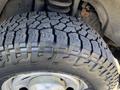 Close-up of a large tire from a 2013 Ford F-250 SD showing a rugged tread pattern designed for off-road and heavy-duty performance