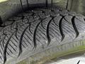 Close-up of a textured tire tread from a 2011 Dodge Grand Caravan showing deep grooves and patterns designed for traction and grip