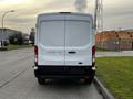 A 2017 Ford Transit van viewed from the rear with a white exterior and black bumpers visible