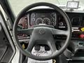 Interior view of a 2006 Freightliner M2 112 showing the steering wheel dashboard and various gauges and controls