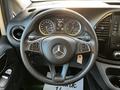 A 2022 Mercedes-Benz Metris steering wheel with controls and dashboard displays visible in the background