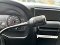 Close-up of the steering wheel and gear shift lever of a 2007 Ford F-550 showing instrument panel and controls